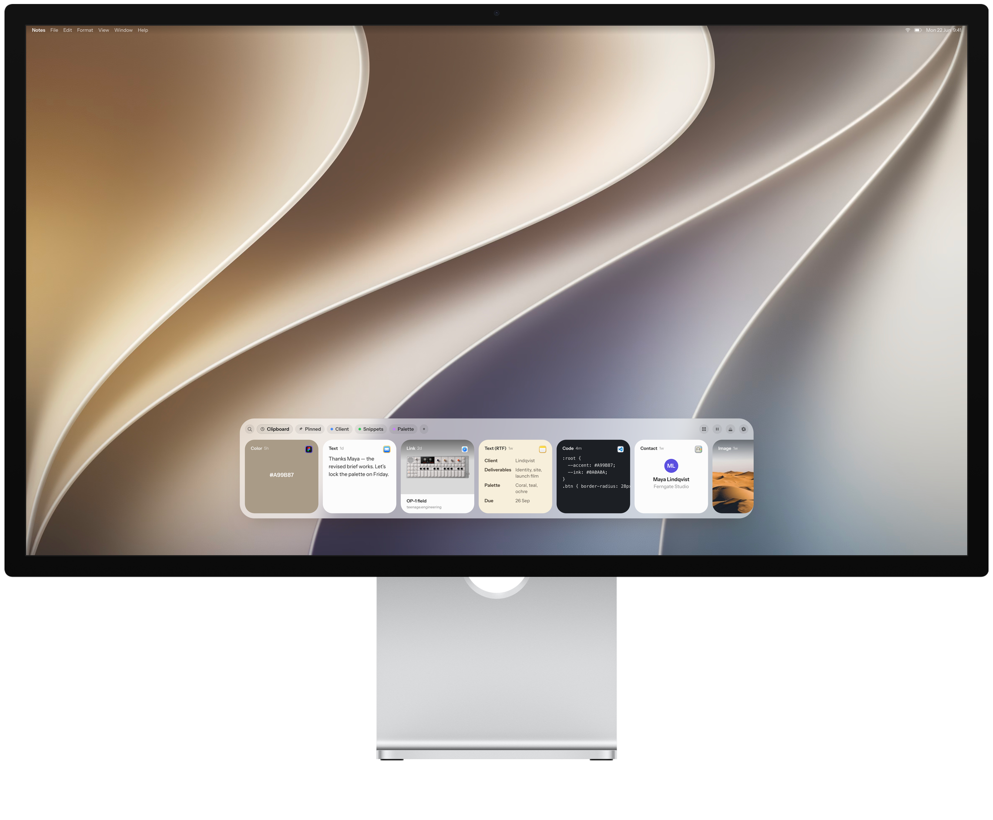 A Studio Display with the Just Copy tray floating along the bottom of the screen, above the Dock